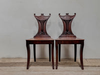 A Pair of Regency Mahogany 'Pelta' Back Hall Chairs in the manner of Gillows